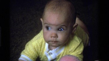 1975: a baby looks at a camera and then picks up toy keys CALIFORNIA