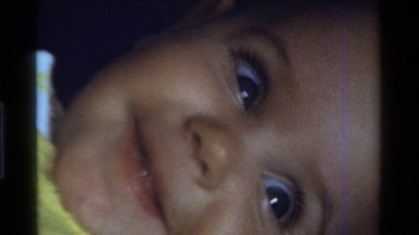 1975: the camera zooms out from the baby lying on the floor CALIFORNIA