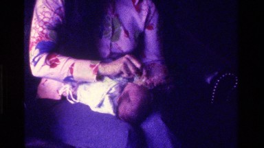 1975: young infant being dressed with pacifier CALIFORNIA