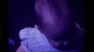 1975: a black and white video of a baby girl waking in a walker