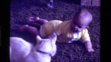 1975: baby and a cat laying together CALIFORNIA
