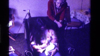 1975: a grandmother looking over a mother and her baby CALIFORNIA
