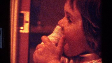 1977: a kid licking her arm CALIFORNIA