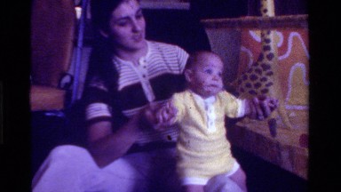 1975: family home-video of mother and her young child happily playing horsey