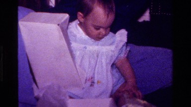 1977: baby opening a gift CALIFORNIA