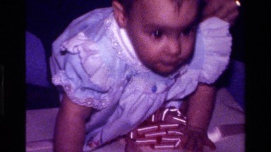 1977: a baby plays with his mom in an environment full of gifts CALIFORNIA