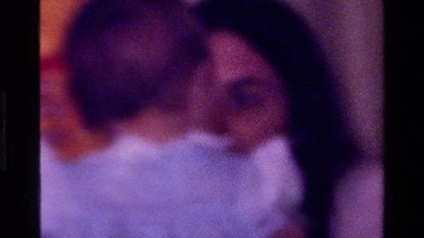 1977: baby in blue ruffled dress with teddy bear walking unsteadily CALIFORNIA
