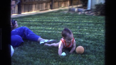 1977: A Small Kid Playing with Ball in a Garden Area California