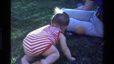 1977: baby crawling in the grass CALIFORNIA