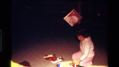 1977: a child playing with santat books CALIFORNIA