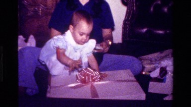 1977: people celebrating and opening a present CALIFORNIA