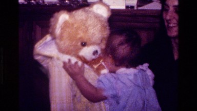 1977: a baby walking with a teddy bear CALIFORNIA