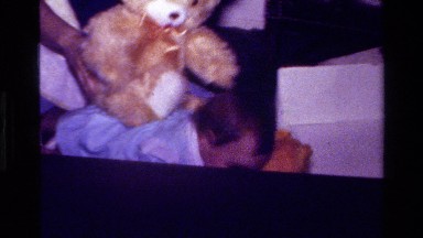 1977: mother and infant daughter playing with a teddy bear CALIFORNIA