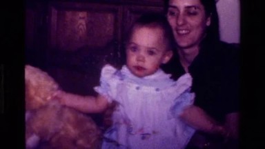 1977: mother with a toddler playing with a stuffed teddy bear gift CALIFORNIA
