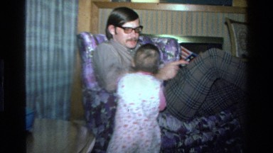 1977: toddler interacting with adult in chair CALIFORNIA
