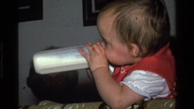 1977: baby drinking a bottle CALIFORNIA