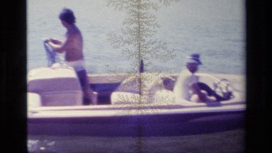 1977: enjoying in the water by surfing with friends in a boat joyfully LAKE