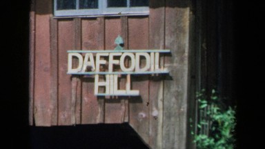 1969: a white sign on a wooden building reads daffodil hill CALIFORNIA