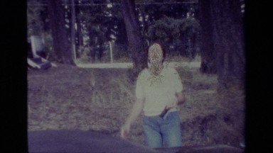 1977: A Woman Running to a Car While Men Talk Behind It in Big Bear California