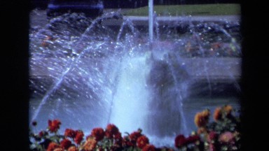 1969: Fountain in Park with View of City Skyline Framed by Trees California