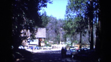 1969: Two People Walk Together Toward Building Near Parking Lot California