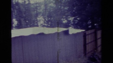 1977: A Grassy Parking Spot Near a Lake Fenced Off by a Privacy Fence