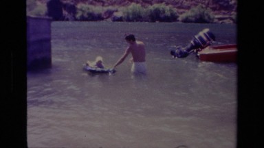 1978: a boy pulls a dog on a floaty in the water CANYON LAKE CALIFORNIA