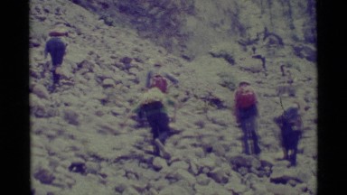 1975: backpackers camping in the wilderness surrounded by granite outcrops