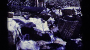 1975: a gently flowing stream flows over rocks on the riverbed MINARET