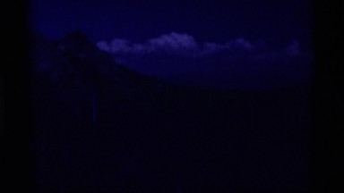 1975: beautiful panorama of peaks and forested hills with a cloudbank