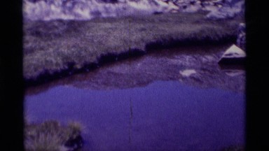 1975: pond with tadpoles; group of backpackers standing at the base of a boulder
