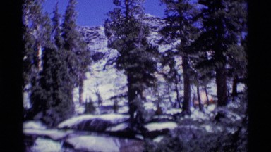 1975: flowing creek on a snowy mountain on a bright sunny day MINARET WILDERNESS