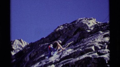 1975: woman rock climbing up the side of a mountain MINARET WILDERNESS