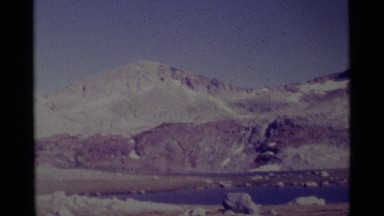 1975: desolate lifeless panorama of rocky hills with lake in front MINARET