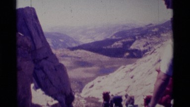 1975: hikers climbing a mountain and overlooking a lake MINARET WILDERNESS
