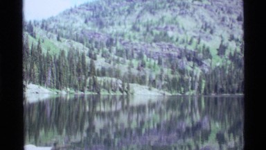 1972: a peaceful view of mountains and rivers showing multiple trees