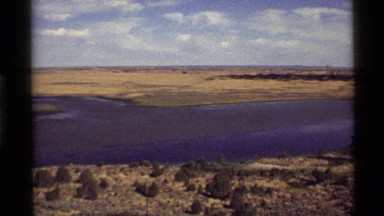 1972: a frozen river winds through a dry landscape in the winter HOLLAND LAKE