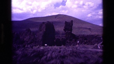 1972: people walking path near weathered rock formations in the desert IDAHO