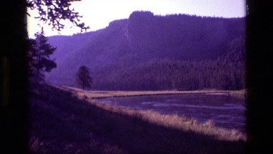 1972: river in forefront; trees and peaks behind IDAHO