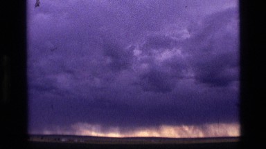 1972: clouds gather, threatening to form a tornado, as two people watch IDAHO