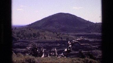 1972: a view of a group of dark mountain tops over a landscape IDAHO