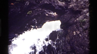 1972: a small waterfall springs from the earth and falls on rocks HOLLAND LAKE