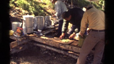 1972: men preparing food outside HOLLAND LAKE MONTANA