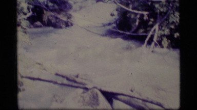 1977: river rushing quickly by a mountain ALASKA