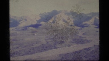 1977: a wide valley surrounded by mountains shows signs of some human
