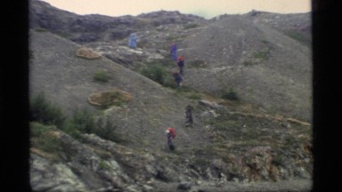 1977: a group of people walk in a straight line down a mountain GLACIER BAY