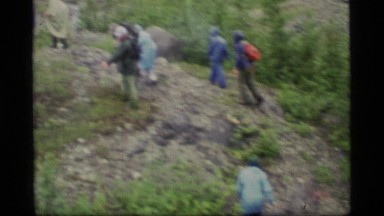 1977: several backpackers walking up a rocky knob and clip of an adjacent peak