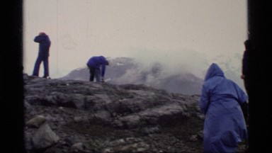 1977: People Outdoors on a Misty Day Gathered on a Rock Knob with Views Glacier