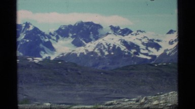 1977: the camera pans across an expansive mountain range GLACIER BAY ALASKA