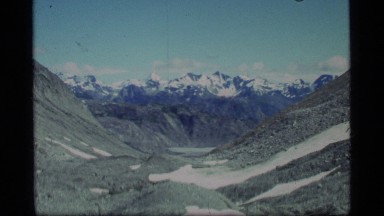 1977: panorama of a mountain valley with trees and jagged peaks GLACIER BAY